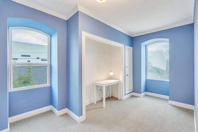 unfurnished bedroom featuring carpet flooring, crown molding, and multiple windows