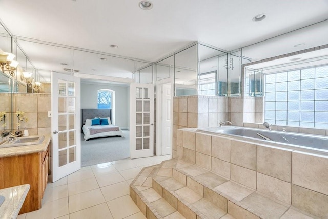 bathroom with french doors, a bath, tile patterned flooring, vanity, and recessed lighting