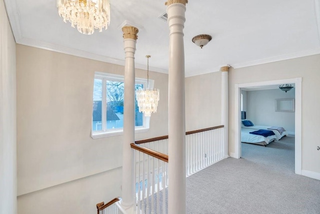 corridor featuring crown molding, baseboards, carpet floors, and a notable chandelier