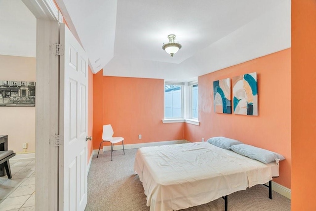 bedroom featuring baseboards and light colored carpet