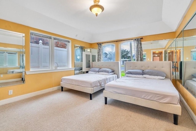 carpeted bedroom featuring baseboards