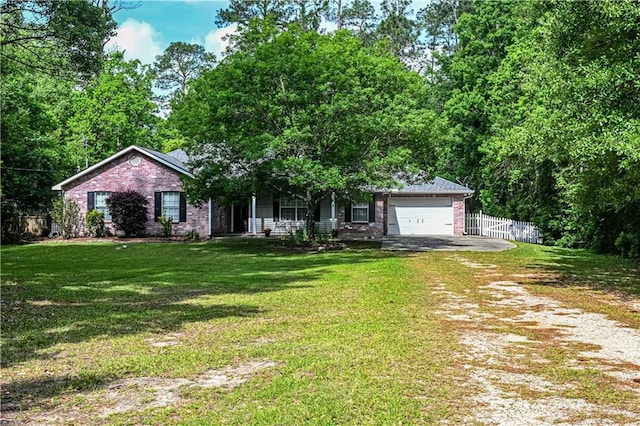 ranch-style home featuring fence, a front lawn, brick siding, a garage, and driveway