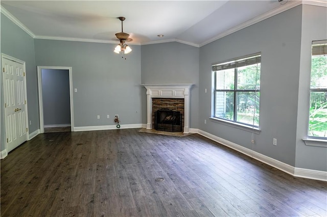 unfurnished living room with crown molding, dark wood-style flooring, a ceiling fan, and a stone fireplace