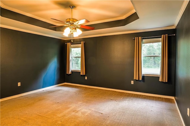 spare room featuring carpet floors, a ceiling fan, and plenty of natural light