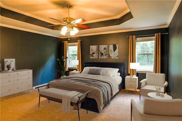 bedroom with a tray ceiling, multiple windows, and ornamental molding
