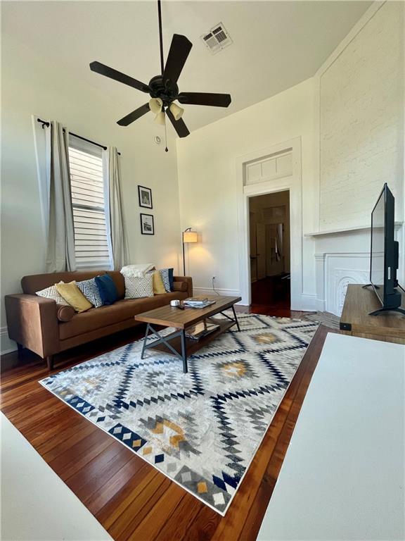 242325 Freret St, New Orleans, LA 70113 - living area featuring visible vents, baseboards, ceiling fan, and wood finished floors