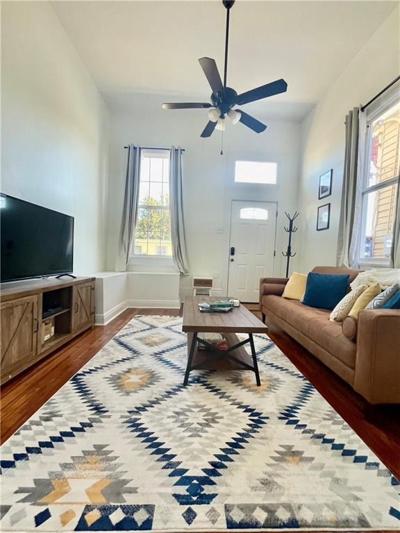 242325 Freret St, New Orleans, LA 70113 - living room featuring baseboards, a ceiling fan, and wood finished floors