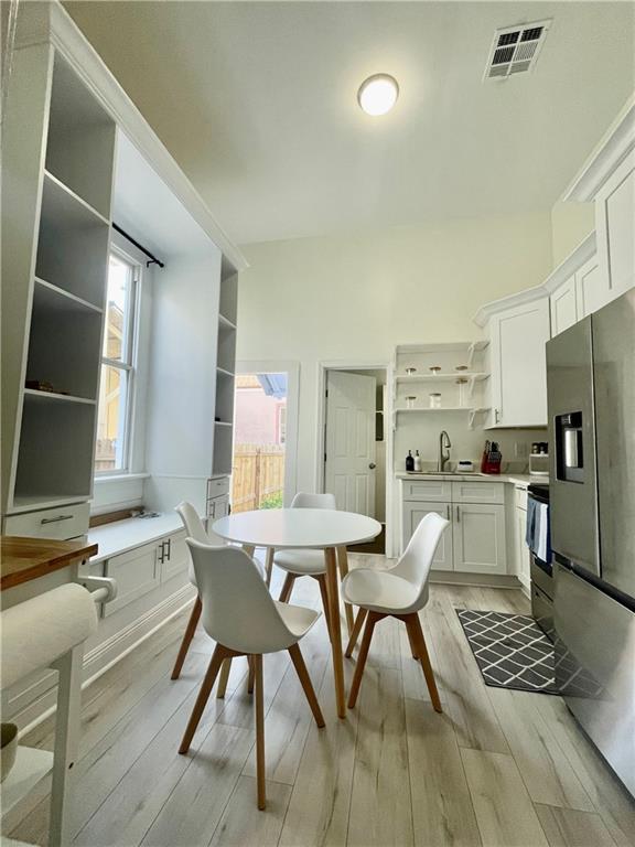 242325 Freret St, New Orleans, LA 70113 - dining space featuring visible vents and light wood-style flooring