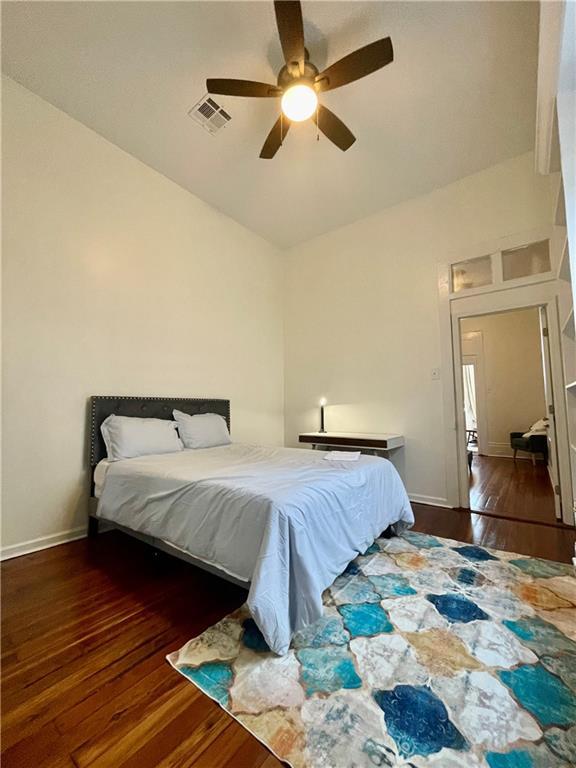 242325 Freret St, New Orleans, LA 70113 - bedroom featuring visible vents, baseboards, ceiling fan, and wood finished floors