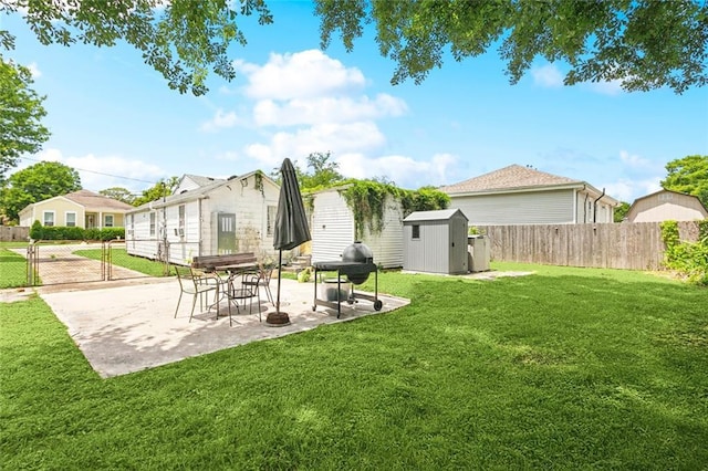 back of house featuring a lawn, a patio area, an outdoor structure, a shed, and a fenced backyard