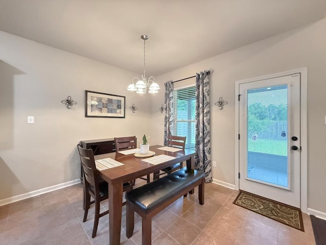 42273 Atmore Pl, Ponchatoula, LA 70454 - dining area featuring baseboards, tile patterned floors, and a chandelier