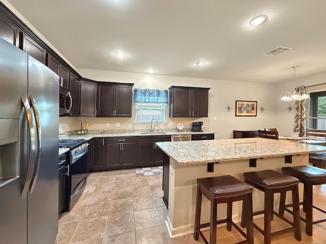 42273 Atmore Pl, Ponchatoula, LA 70454 - kitchen featuring visible vents, a sink, a breakfast bar area, and stainless steel appliances