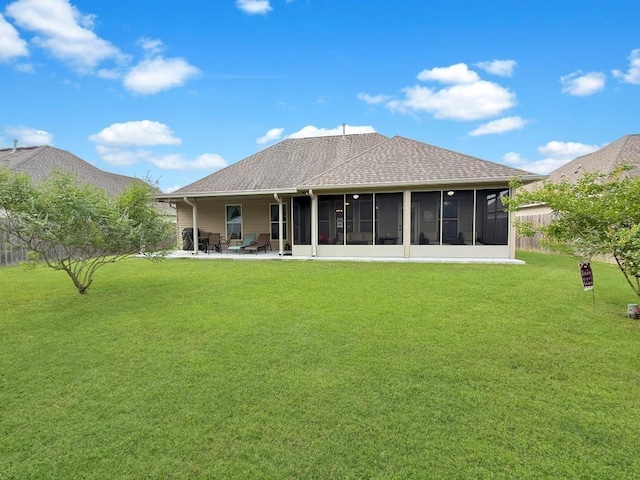 42273 Atmore Pl, Ponchatoula, LA 70454 - back of house with a sunroom, a lawn, a patio area, and roof with shingles