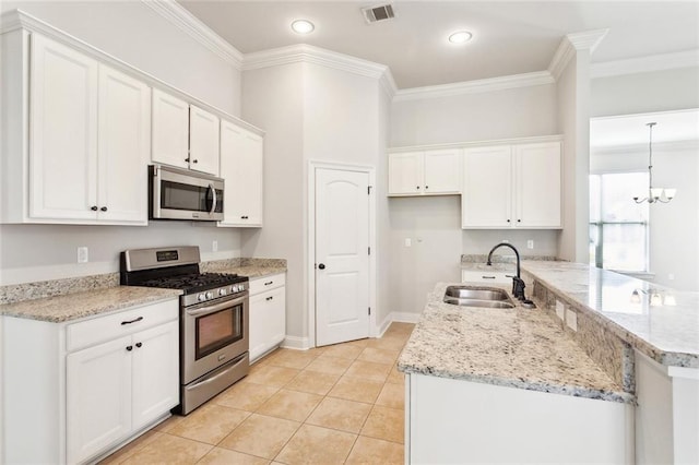 kitchen with visible vents, appliances with stainless steel finishes, a sink, ornamental molding, and white cabinetry