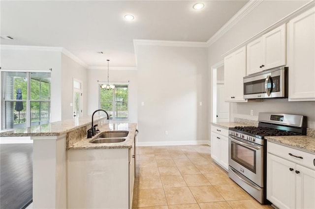 kitchen with ornamental molding, recessed lighting, a sink, appliances with stainless steel finishes, and a notable chandelier