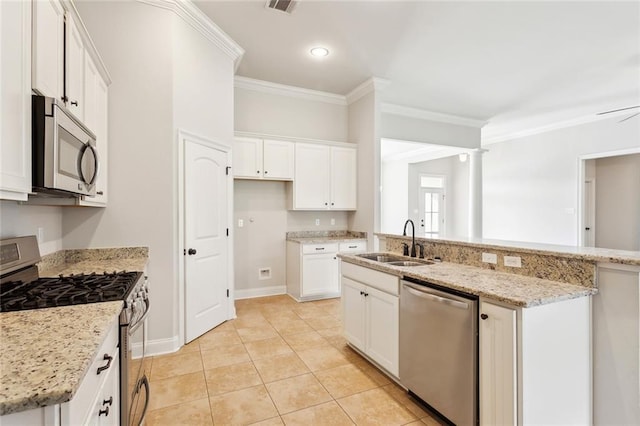 kitchen featuring a sink, light stone counters, white cabinets, ornamental molding, and stainless steel appliances