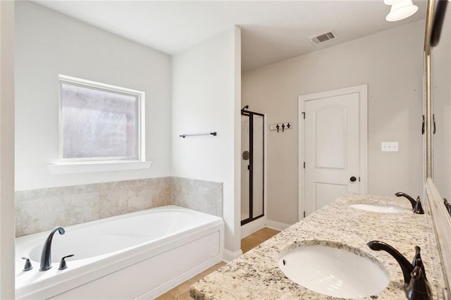 bathroom featuring a sink, a shower stall, a bath, and visible vents