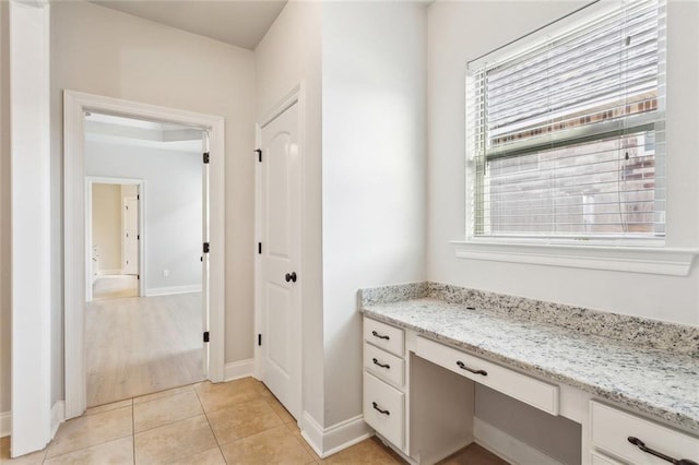 bathroom featuring tile patterned floors, plenty of natural light, baseboards, and vanity