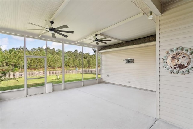 unfurnished sunroom with ceiling fan