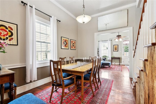 dining space featuring ceiling fan, plenty of natural light, stairway, and hardwood / wood-style floors