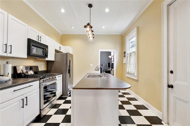 kitchen featuring dark floors, appliances with stainless steel finishes, dark countertops, and a sink