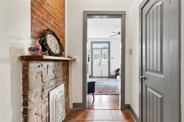 corridor with baseboards and tile patterned flooring