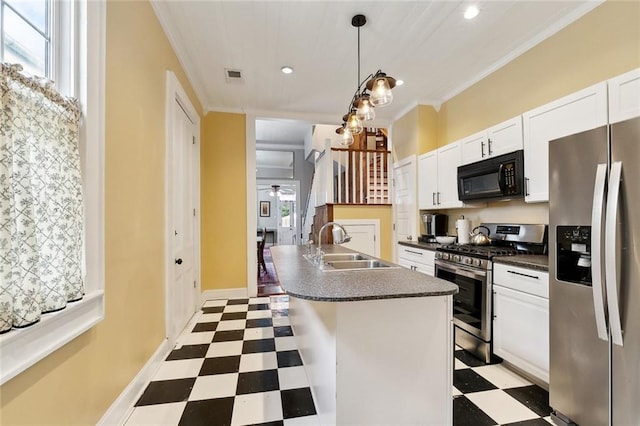kitchen with a sink, light floors, crown molding, and stainless steel appliances