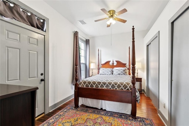 bedroom with visible vents, baseboards, ceiling fan, and wood finished floors