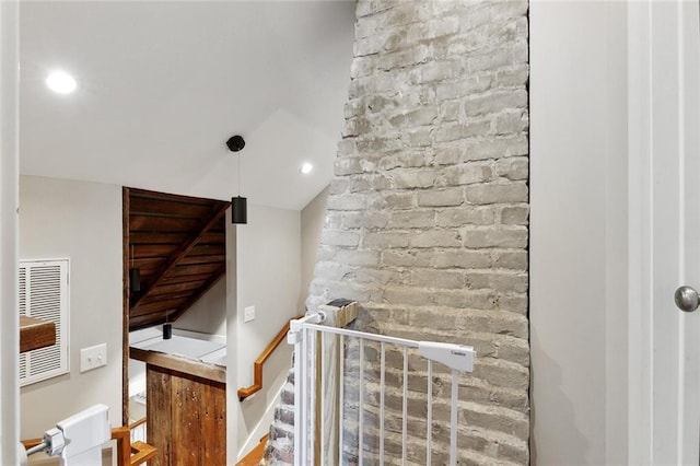 staircase featuring visible vents, recessed lighting, and lofted ceiling