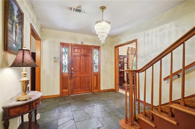 2363 Lark St, New Orleans, LA 70122 - entryway with stone tile floors, a chandelier, and stairway