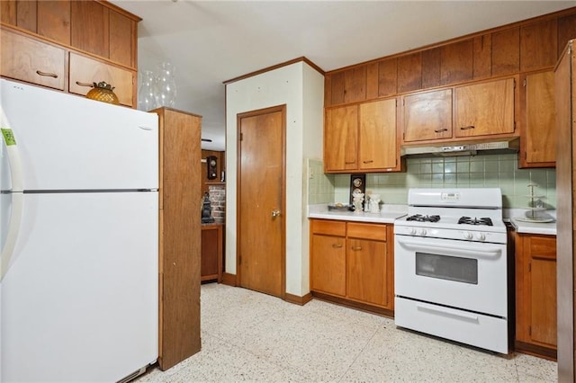 2363 Lark St, New Orleans, LA 70122 - kitchen featuring white appliances, under cabinet range hood, light countertops, tasteful backsplash, and brown cabinetry