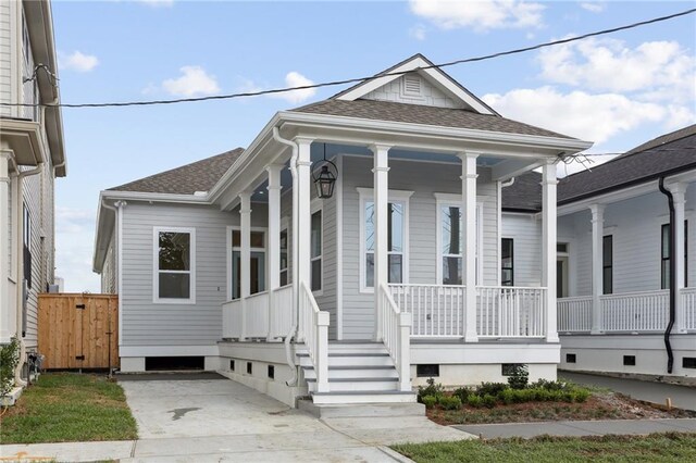 537 Thayer St, New Orleans, LA 70114 - shotgun-style home with roof with shingles and a porch
