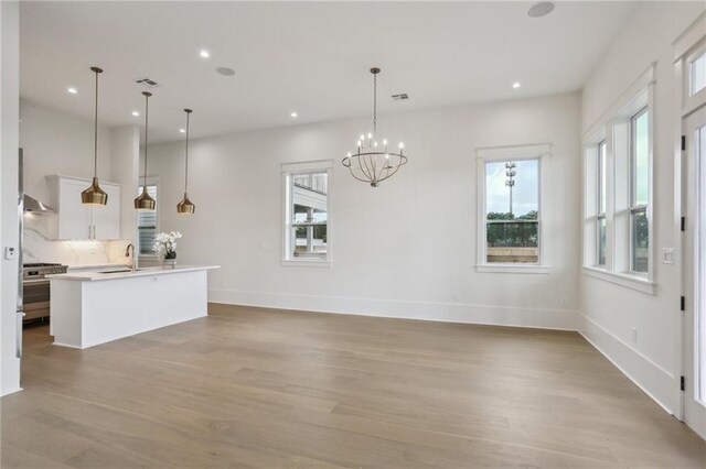 537 Thayer St, New Orleans, LA 70114 - kitchen featuring high end stainless steel range, recessed lighting, light wood-style flooring, and white cabinetry