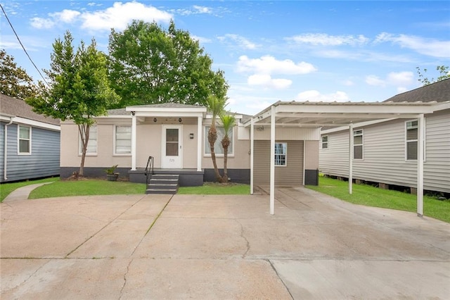 view of front of house featuring driveway and an attached carport