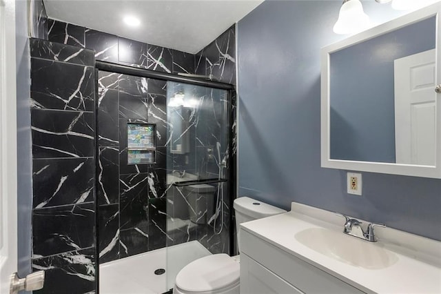 full bathroom featuring vanity, a marble finish shower, and toilet
