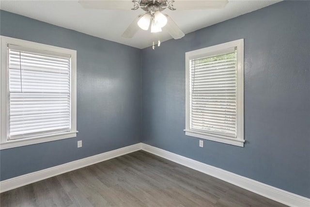empty room featuring baseboards, ceiling fan, and wood finished floors