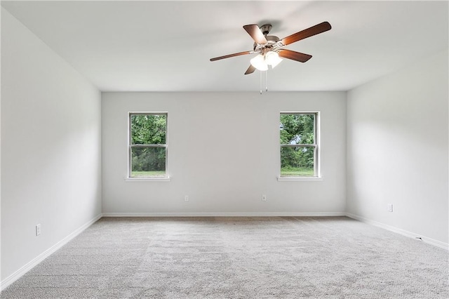 empty room featuring ceiling fan, carpet, and baseboards