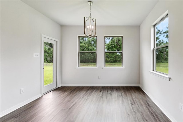 unfurnished room with a chandelier and plenty of natural light