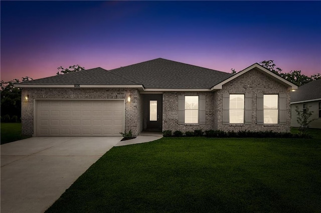 ranch-style home with concrete driveway, a garage, brick siding, and a front yard