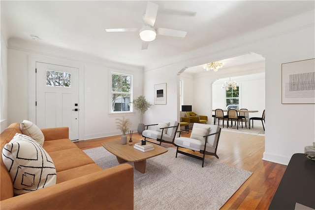 316 Claiborne Ct, Jefferson, LA 70121 - living area with arched walkways, baseboards, wood finished floors, and ceiling fan with notable chandelier
