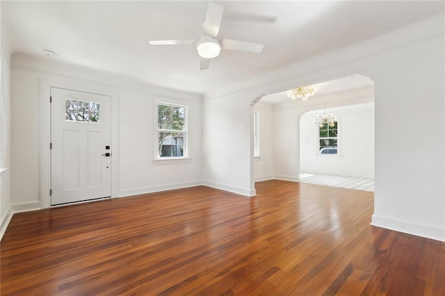 316 Claiborne Ct, Jefferson, LA 70121 - foyer with arched walkways, baseboards, ceiling fan with notable chandelier, and wood finished floors