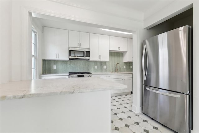 316 Claiborne Ct, Jefferson, LA 70121 - kitchen featuring a sink, white cabinetry, and stainless steel appliances