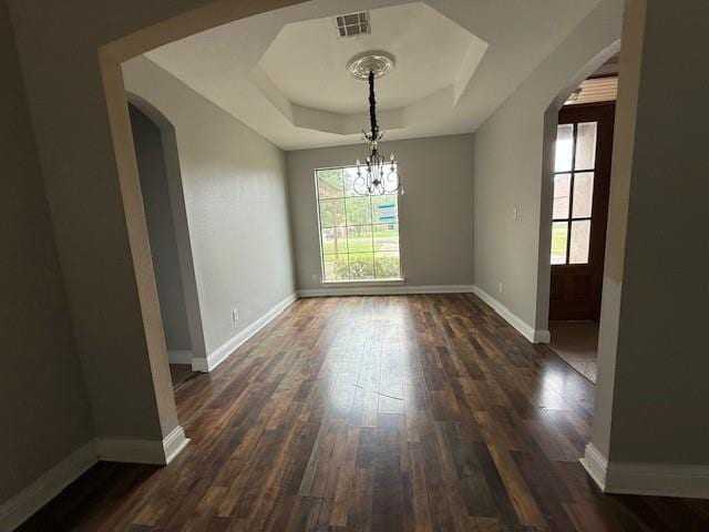 12742 Diamond Lake Dr, Walker, LA 70785 - unfurnished dining area with arched walkways, a raised ceiling, healthy amount of natural light, and dark wood-style floors