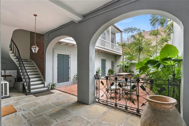 415 Burgundy St Unit 1B, New Orleans, LA 70112 - view of patio / terrace featuring stairs, outdoor dining area, and ac unit