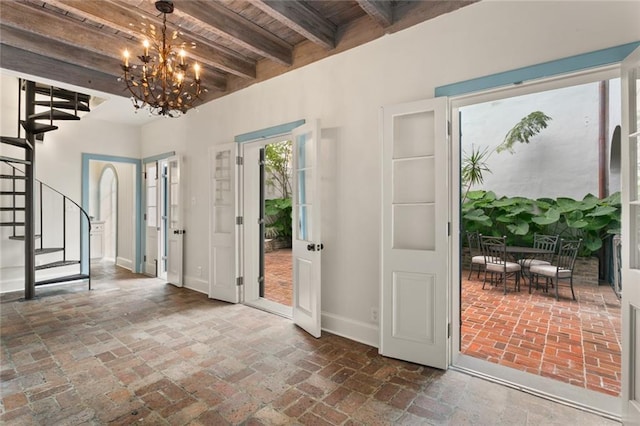 415 Burgundy St Unit 1B, New Orleans, LA 70112 - foyer featuring brick floors, stairs, baseboards, a chandelier, and wooden ceiling with exposed beams