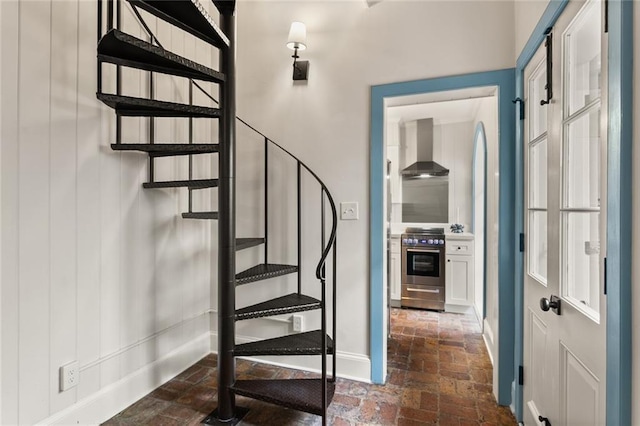 415 Burgundy St Unit 1B, New Orleans, LA 70112 - staircase with brick floors and baseboards