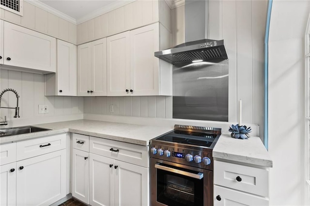 415 Burgundy St Unit 1B, New Orleans, LA 70112 - kitchen with stainless steel electric range oven, a sink, wall chimney exhaust hood, white cabinets, and crown molding