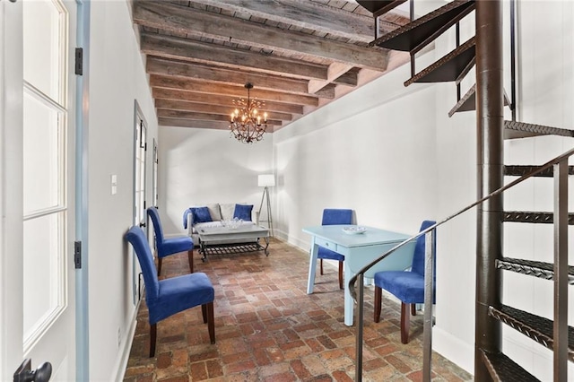 415 Burgundy St Unit 1B, New Orleans, LA 70112 - interior space with baseboards, brick floors, a chandelier, and wooden ceiling with exposed beams