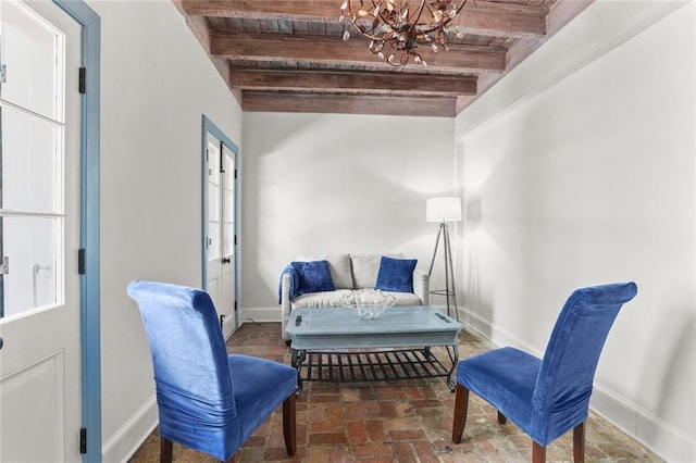 415 Burgundy St Unit 1B, New Orleans, LA 70112 - living area with wood ceiling with exposed beams, baseboards, and a chandelier