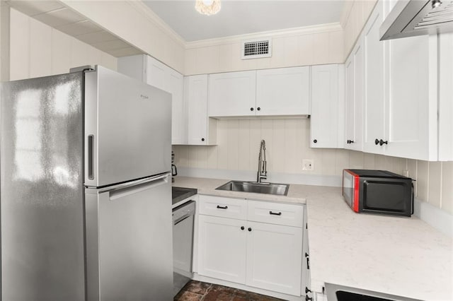 415 Burgundy St Unit 1B, New Orleans, LA 70112 - kitchen featuring appliances with stainless steel finishes, a sink, white cabinetry, light countertops, and ornamental molding